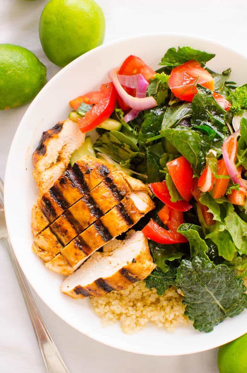 Sliced chili lime chicken served with salad and quinoa.