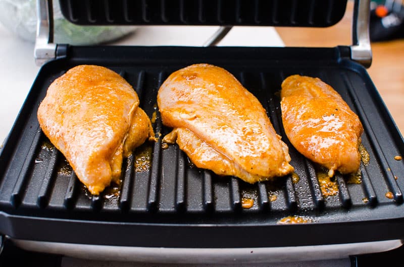 Marinated chili lime chicken breasts on the grill.