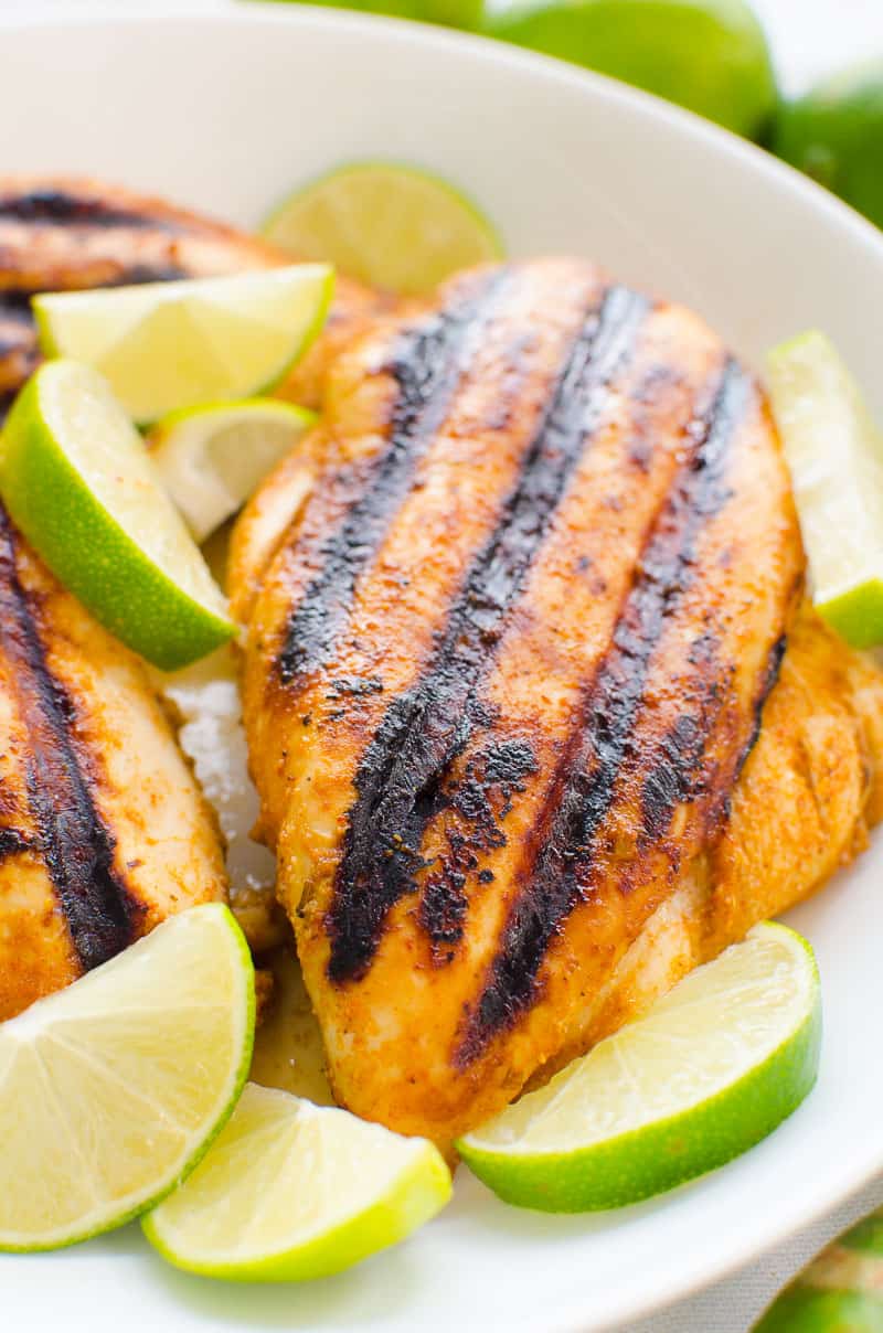 plate of chili lime chicken breasts garnished with lime wedges