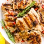 Overhead view of grilled chicken thighs seasoned with Greek chicken marinade.