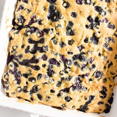 Healthy blueberry breakfast cake in white baking dish.