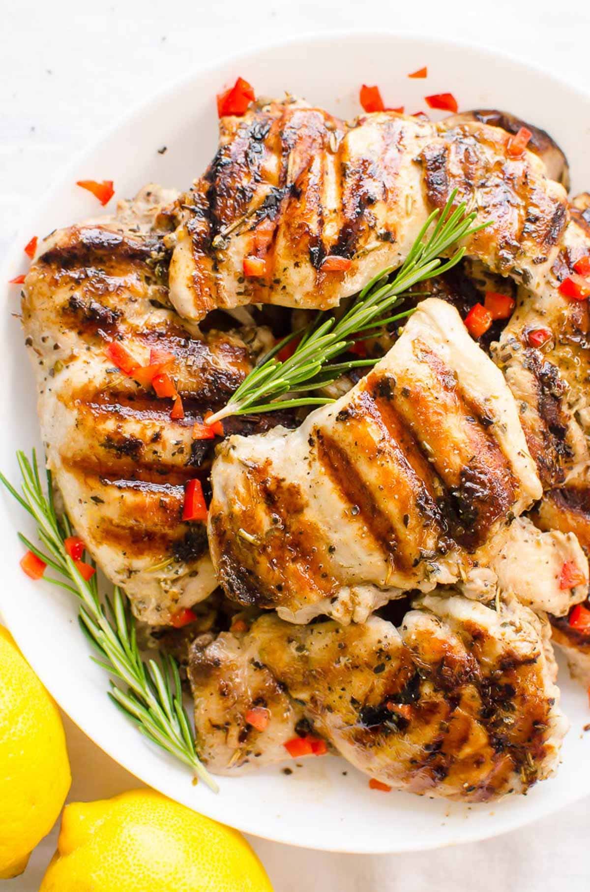 Overhead view of grilled chicken thighs seasoned with Greek chicken marinade.