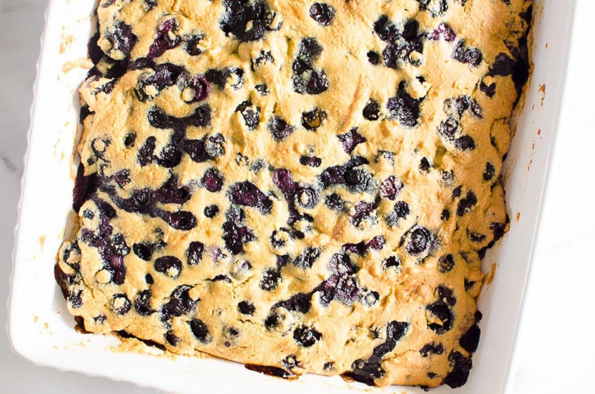 Healthy blueberry breakfast cake in white baking dish.