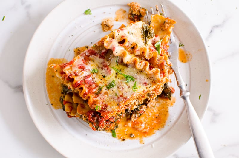 instant pot lasagna served on a white plate with a fork