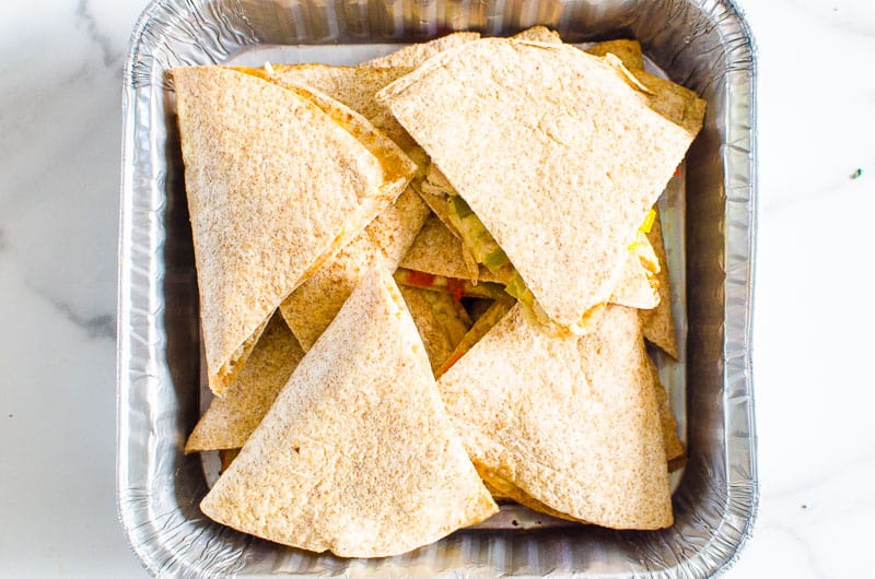 chicken and cheese quesadilla placed in a metal tray for on the go eating