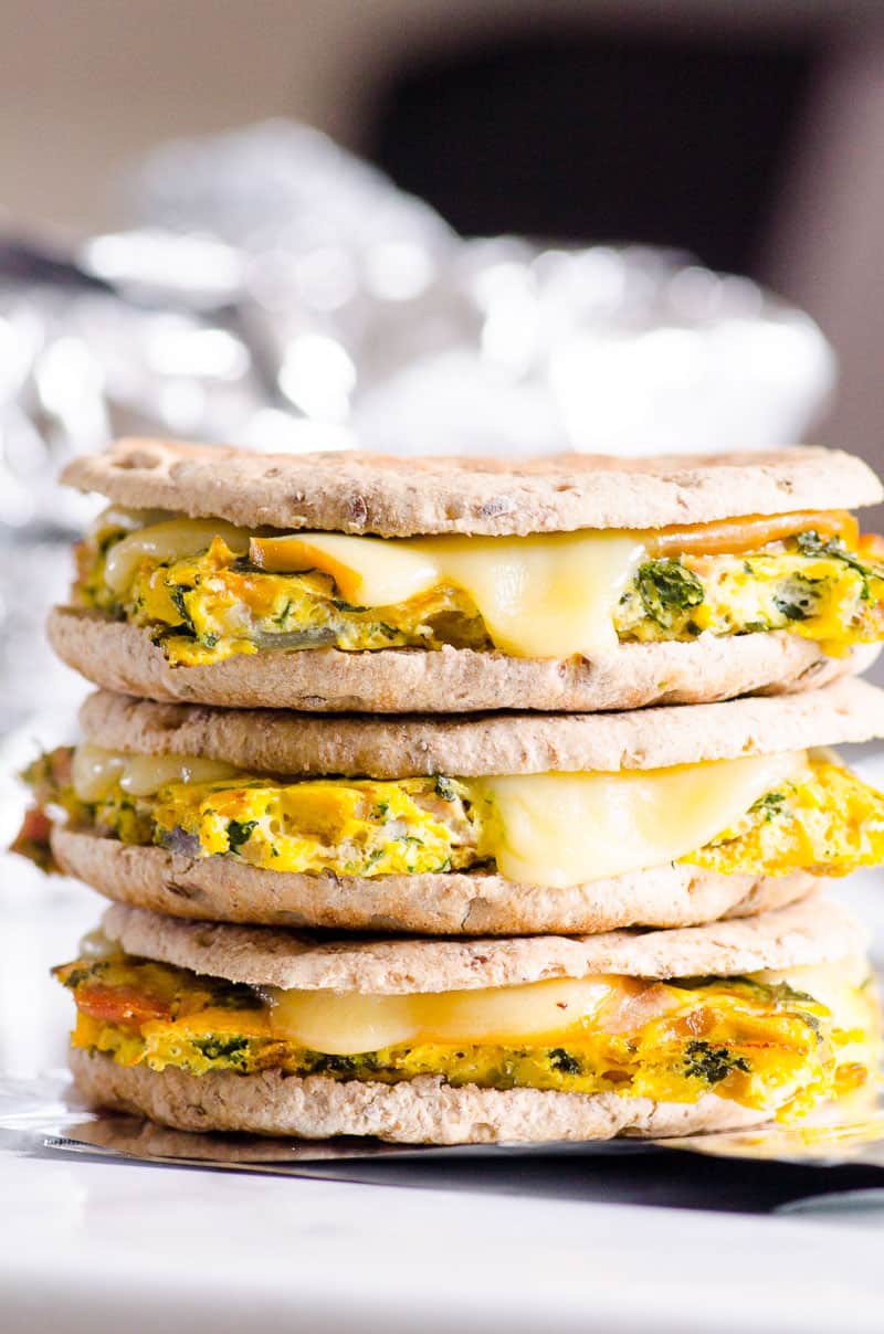 Make ahead Healthy Breakfast Sandwich with melted cheese stacked to show texture
