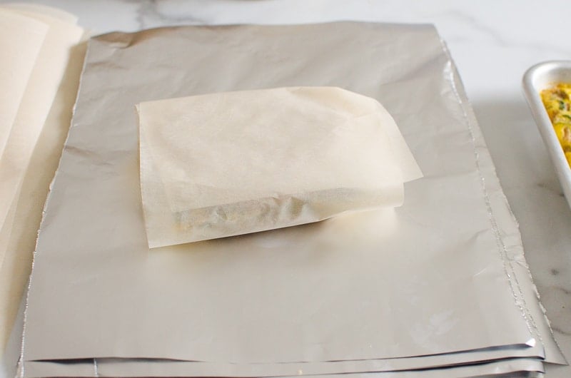 showing how sandwich is wrapped in parchment paper first