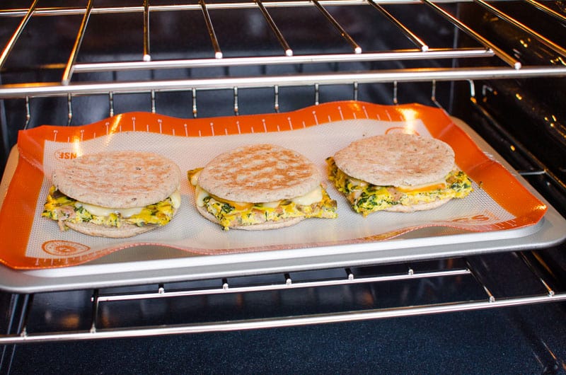 Reheating healthy breakfast sandwiches in the oven.