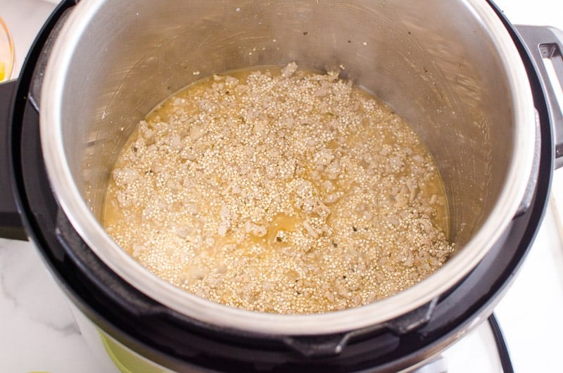 Instant pot with liquids and quinoa.