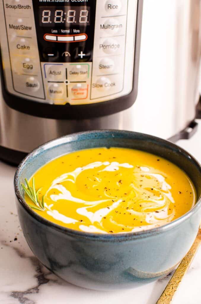 creamy dairy free squash soup in a bowl with Instant Pot in background