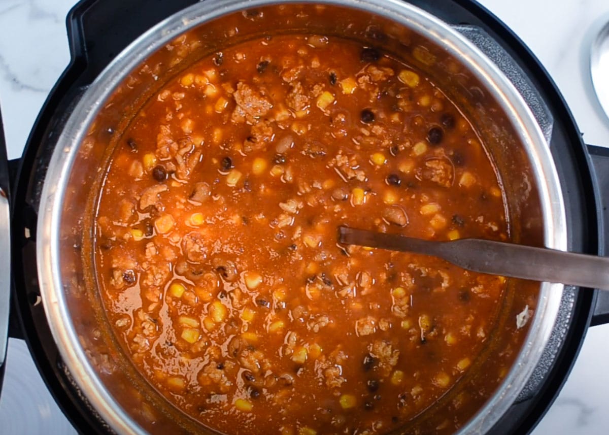 Taco soup in Instant Pot with soup ladle. 