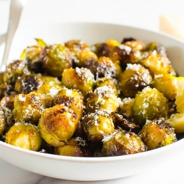 Parmesan roasted Brussels sprouts in a white serving bowl.