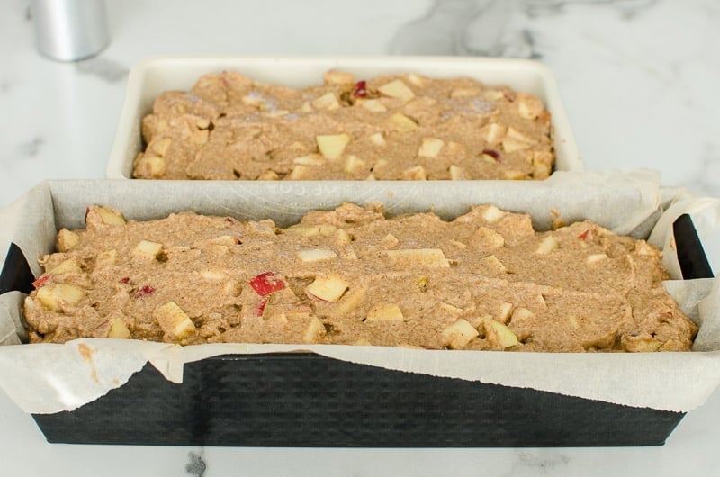 Two loaf pans of unbaked healthy apple bread batter.