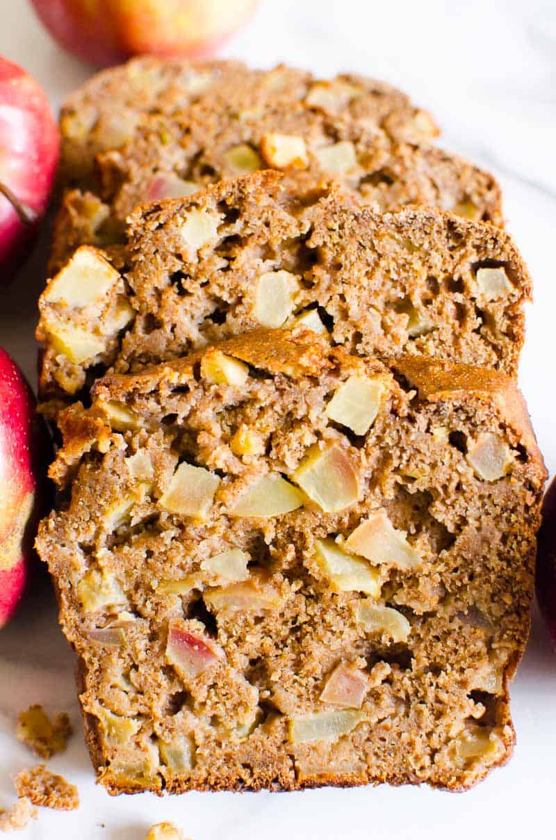 Healthy apple bread sliced on white platter.