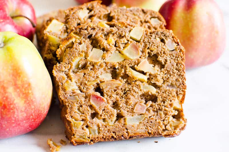 Sliced healthy apple bread with fresh apples.