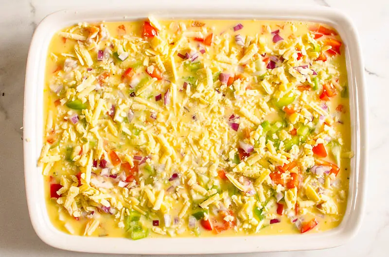 sprinkle red onion and cheese on breakfast egg bake casserole