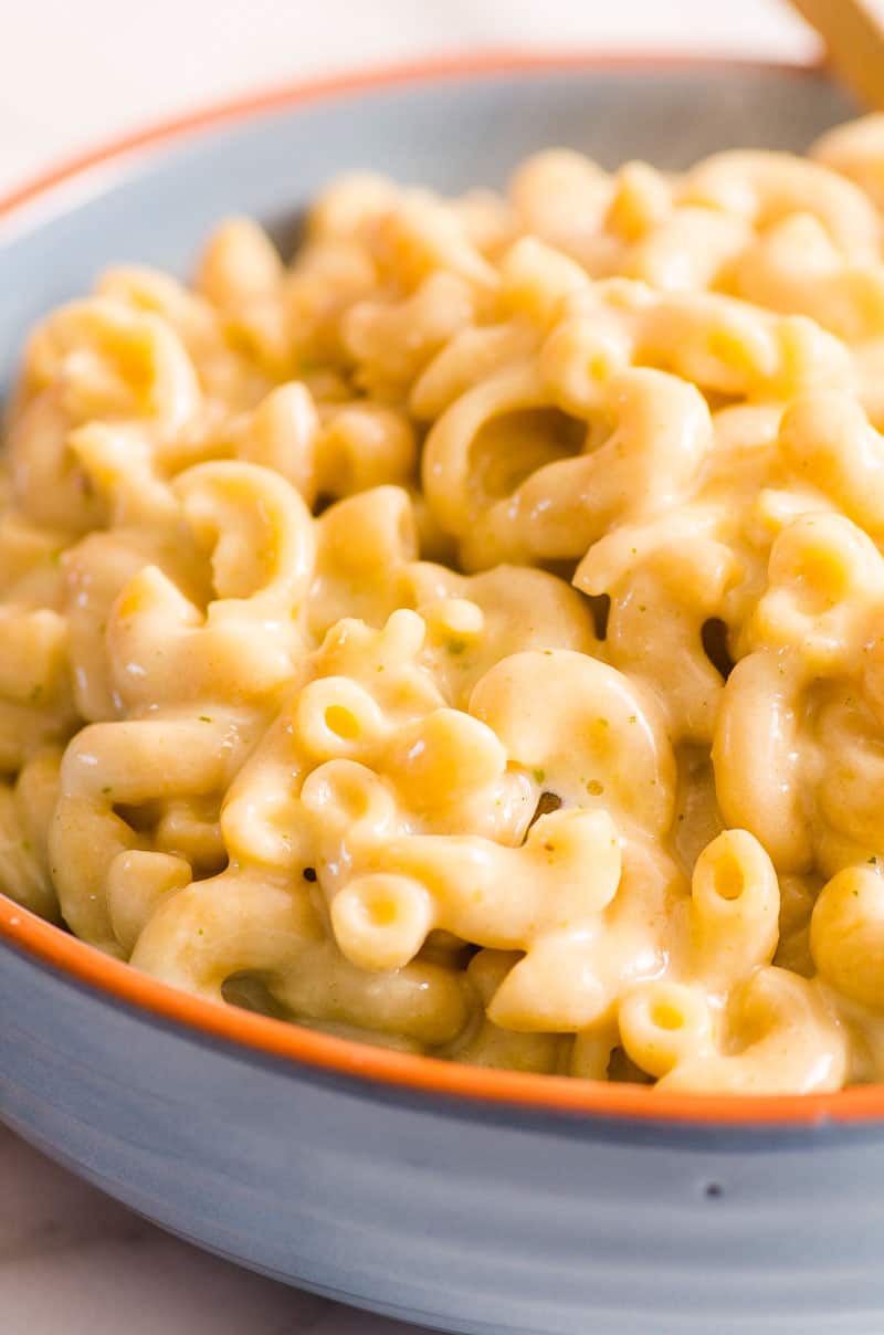 Healthy mac and cheese served in blue bowl.