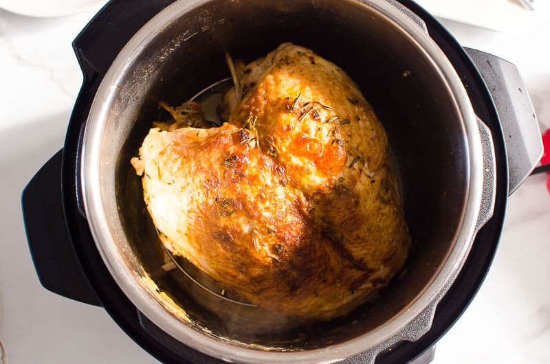 Instant Pot turkey breast in pressure cooker pot.