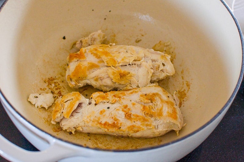Two chicken breasts browned in large pot.