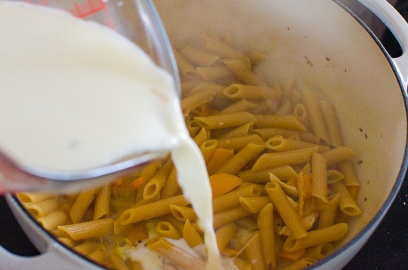 Add cream to pot for tuscan chicken pasta