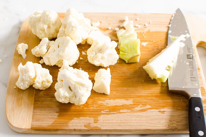 Cauliflower florets on cutting board. 