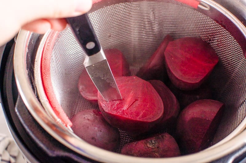 Piercing a beet with a knife. 