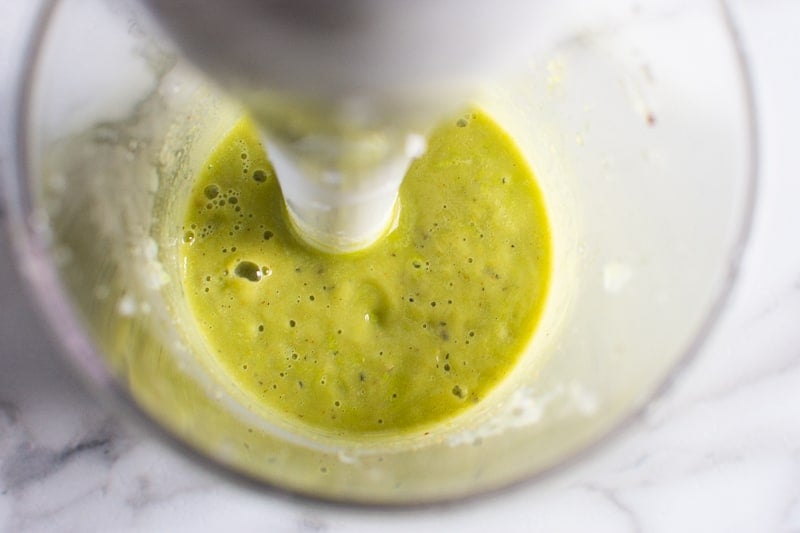 cilantro avocado dressing in a cup made with blender
