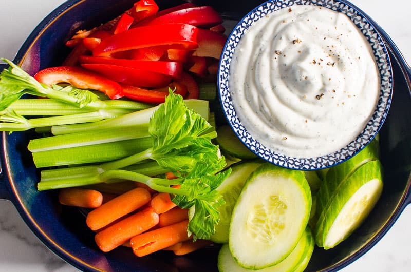 healthy veggie dip on platter with fresh cut vegetables