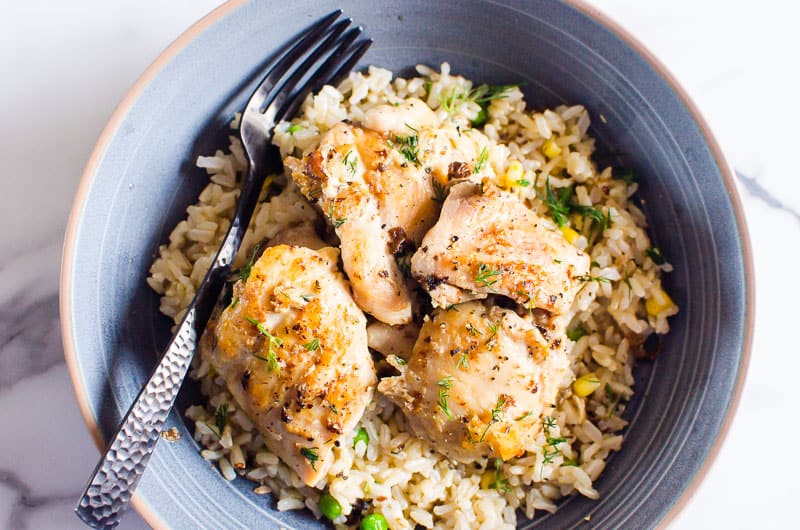 instant pot chicken thighs served with rice on blue plate