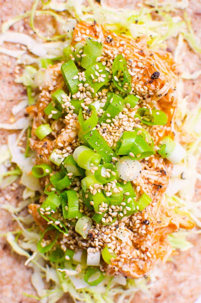 Instant Pot BBQ Chicken with cabbage, avocado, green onion and sesame seeds in a wrap