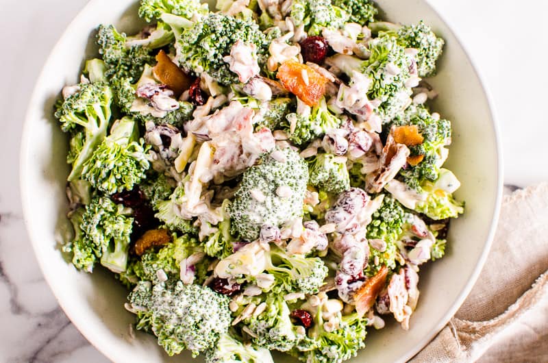 healthy broccoli salad served in a white bowl