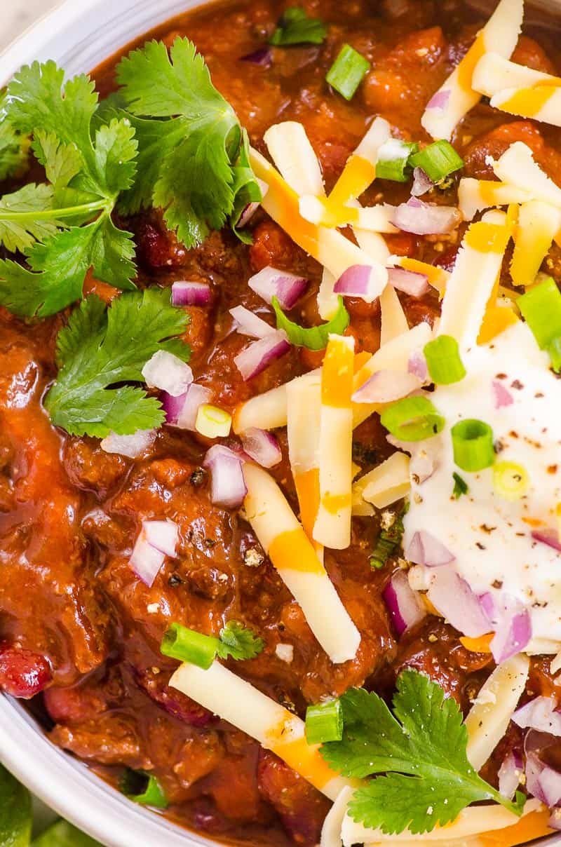 Instant Pot Chili Recipe topped with cheese onion cilantro