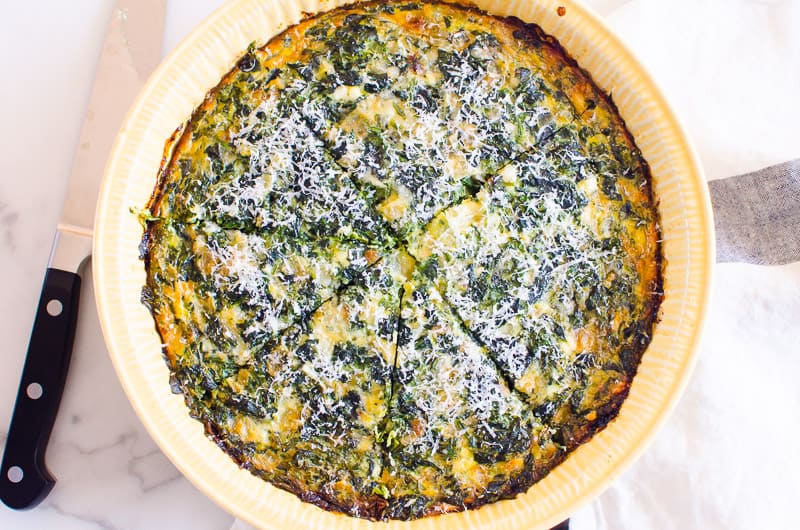 crustless spinach quiche sliced with a knife
