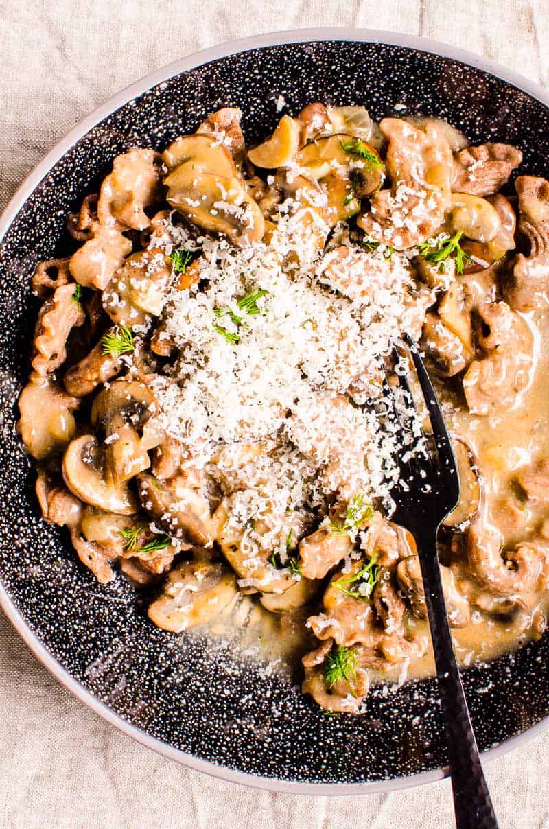 mushroom stroganoff with garnish of dill and parmesan