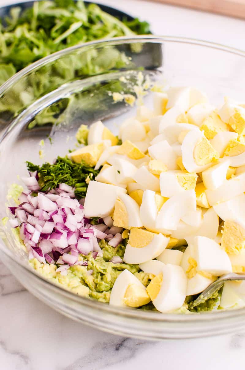 Avocado Egg Salad recipe ingredients in a clear bowl