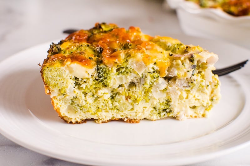 Crustless Broccoli Quiche slice on a white plate and with black fork