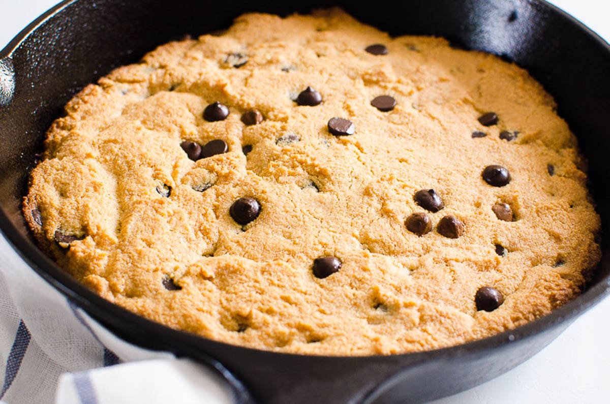 Almond flour skillet cookie with chocolate chips in cast iron skillet.