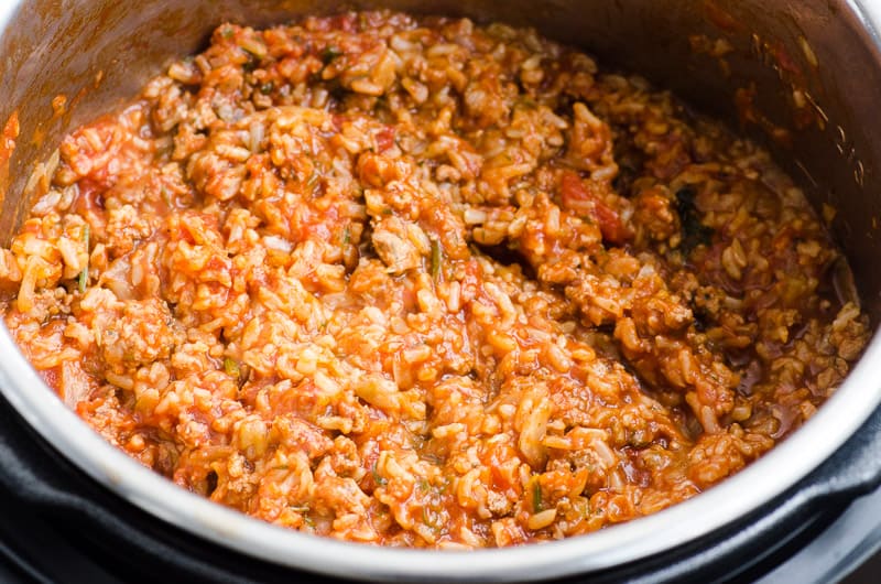 Instant Pot cabbage rolls with ground turkey, rice, seasonings and tomatoes.
