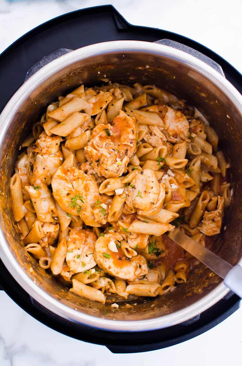 Instant Pot Parmesan Chicken Pasta in a pot with a spoon