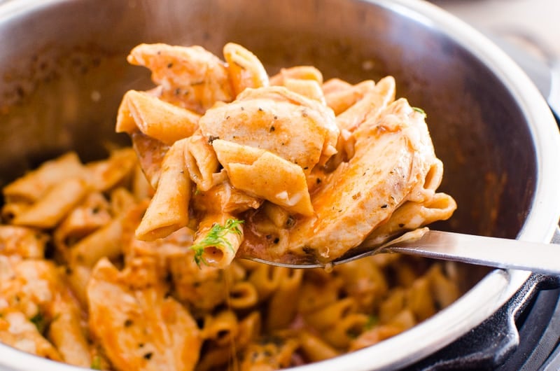 instant pot chicken pasta with parmesan scooped on a spoon