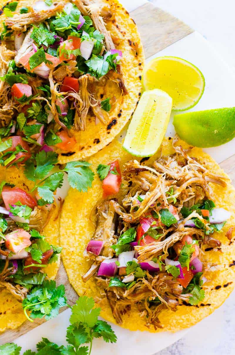 Instant Pot Carnitas served on a marble tray with lime