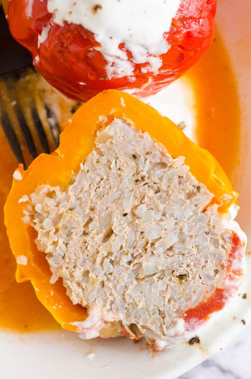 Instant Pot Stuffed Pepper cut in half and served with yogurt and pepper