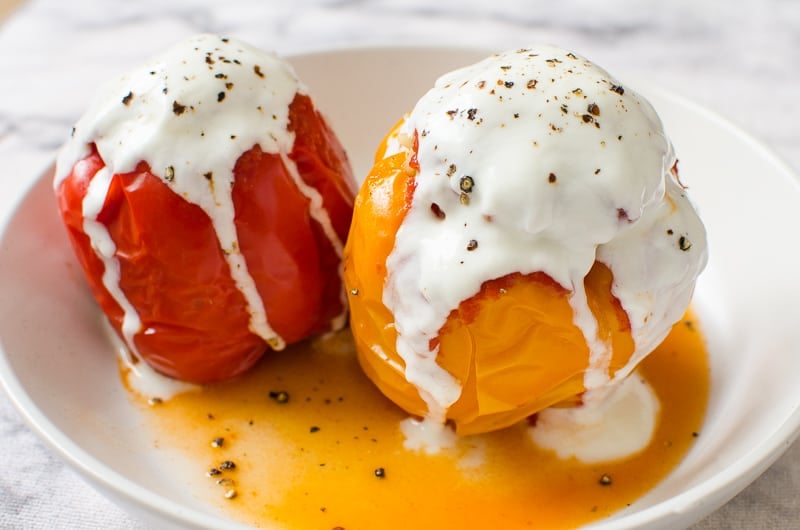 instant pot stuffed peppers on plate with juices and yogurt for topping