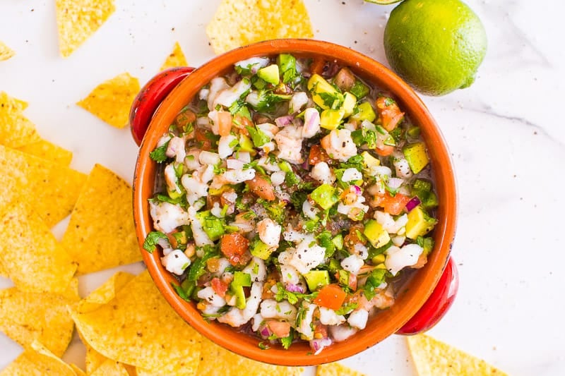 Shrimp ceviche in a bowl with tortillas.