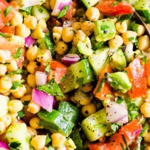 Chickpea salad with avocado, cucumbers, tomato and red onion.