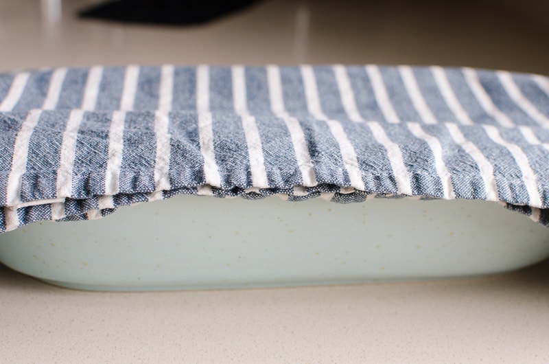 A towel covering a dish.