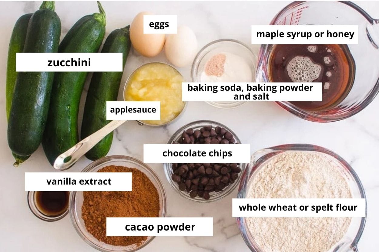 Chocolate chips, zucchini, applesauce, cacao powder, eggs, baking staples, and whole wheat flour.