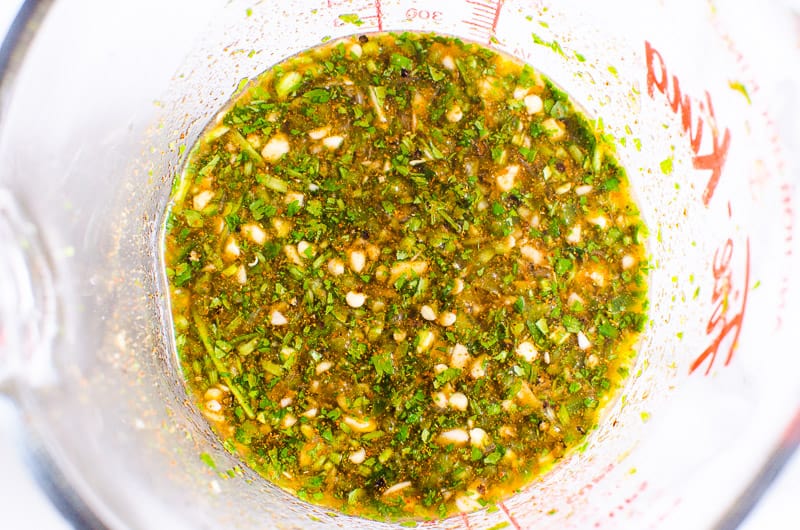 Soy sauce, apple cider vinegar, lime juice, cilantro, garlic, jalapeno and seasonings in bowl.