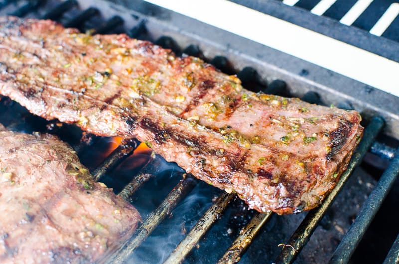 Carne asada steaks on a grill.