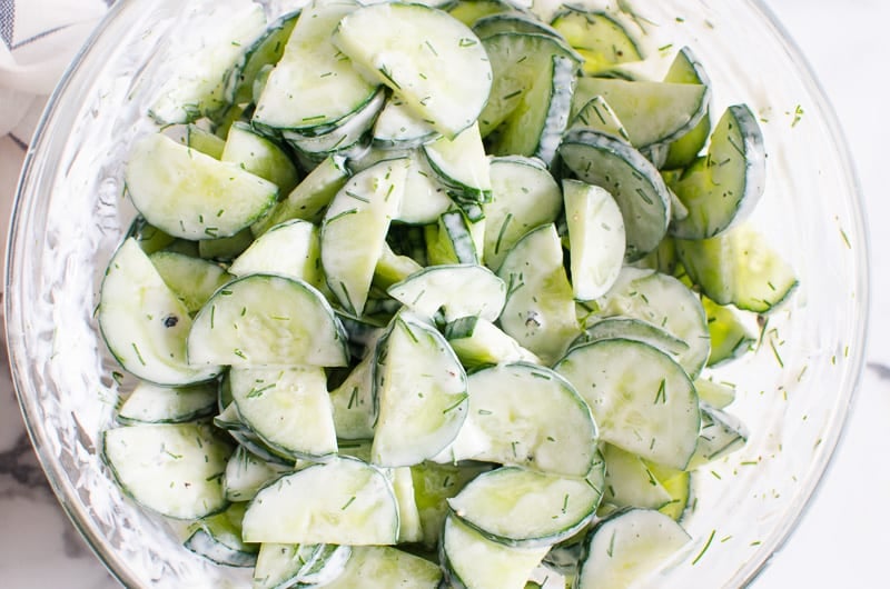 creamy cucumber salad with herbs in a bowl